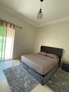 a bedroom with a bed and a rug at Kawtar in Pont Blondin +7 photos