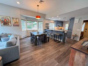 a living room with a couch and a table at F32 Modern Golf Course Home with Mountain Views in Bretton Woods