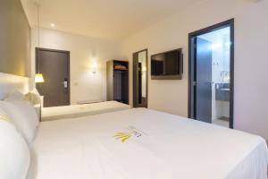 Postel nebo postele na pokoji v ubytování Uniclass Hotel Pinheiros