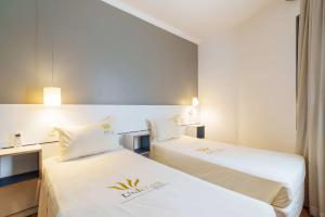 Postel nebo postele na pokoji v ubytování Uniclass Hotel Pinheiros