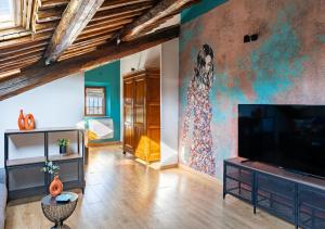 a living room with a large flat screen tv at Roma 20min-Elegante Loft Storico Grottaferrata in Grottaferrata