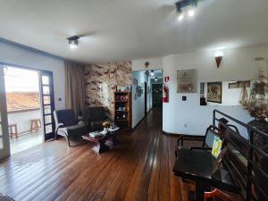 a living room with a couch and a table at POUSADA FLOR DE LIS in Diamantina