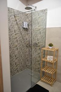 a shower in a bathroom with a wall at Casa Asprigna in Ficarazzi