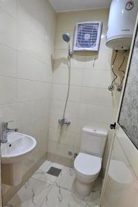 a bathroom with a toilet and a sink at استديو مفروش فرش فندقي in 6th Of October