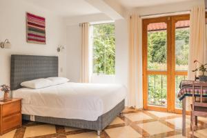 Postel nebo postele na pokoji v ubytování Sueños del Valle Sagrado