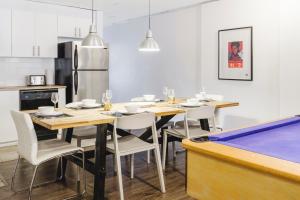 a dining room with a table and a pool table at MtlVacationRentals - The Entertainer in Montréal
