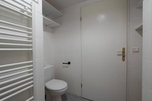 a white bathroom with a toilet and a shower at Studio JadOr gare RER B Le Bourget - Paris aeroport Charles de Gaulle in Le Bourget +19 photos