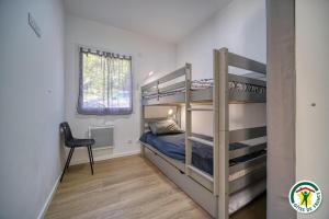 a bedroom with two bunk beds and a desk at Gîte La Bauge 1 à 7 personnes 26400 Montclar sur Gervanne in Montclar-sur-Gervanne