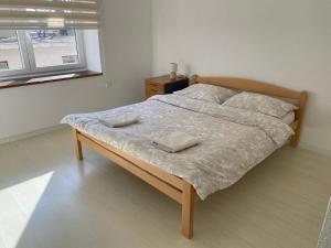 a bedroom with a bed with two towels on it at Apartmani Posušje in Posušje