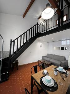 a living room with a table and a staircase at Central Super Loft in Nice