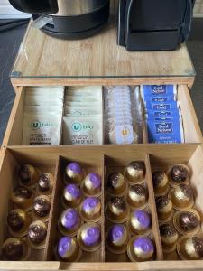 a box of chocolate donuts on a shelf at Central Super Loft in Nice