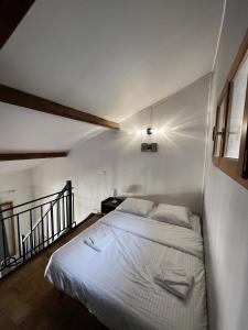 a white bed in a room with a staircase at Central Super Loft in Nice