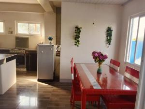 a kitchen and dining room with a table and a refrigerator at Mountain cove villa in Pagudpud