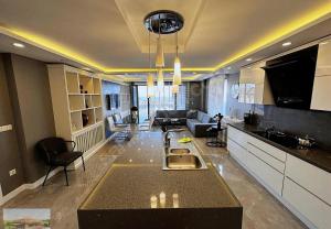 a large kitchen and living room with a couch at selimpiya villaları in Silivri