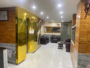 a living room with couches and a couch at Royal Continental Hotel Gojra in Muzaffarabad