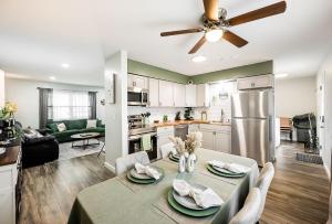 a kitchen and living room with a table and a ceiling fan at Meadow View BNB in Lima +103 photos