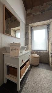 a bathroom with a sink and a mirror at Casa do Páteo in Macieira de Alcoba +24 photos