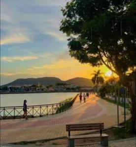 a park with a bench next to a body of water at Apartamento Centro de Tauá in Tauá