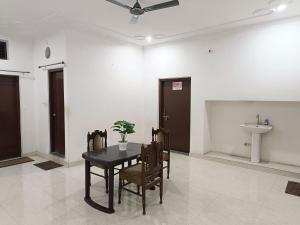 a dining room with a table and a sink at The Wings Home Your Home Away From Home 2 BHK in Kakarmatha