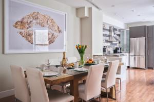 a kitchen and dining room with a wooden table and chairs at MTLVacationRentals - The FabFour in Montreal