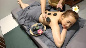a woman laying on a bed with a dress on at X One Hotel in Phnom Penh