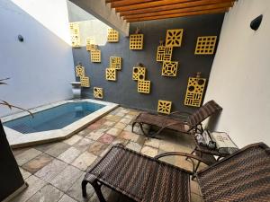 a patio with two chairs and a swimming pool at Shop Motel in Campina Grande