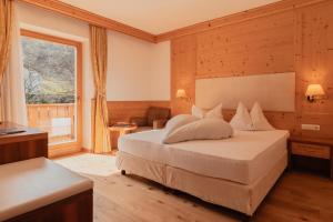 Postel nebo postele na pokoji v ubytování Naturhotel Sonnenhof
