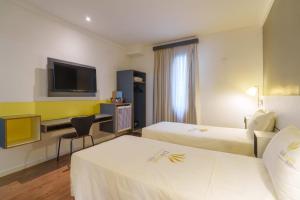 Postel nebo postele na pokoji v ubytování Uniclass Hotel Pinheiros