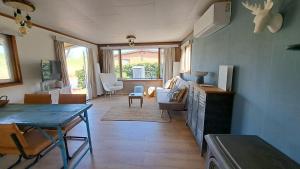 a living room with a table and a dining room at Waterlodge met waterfiets op monumentaal fort in Ooltgensplaat