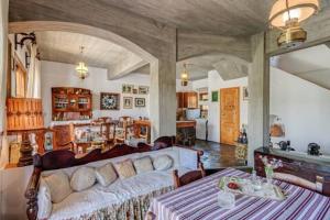 a living room with a couch and a table at Lilly Traditional Cretan Villa in Dhrakóna