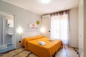 a bedroom with a bed with two towels on it at Hotel sul Mare e Lido Atena in Paestum +38 photos