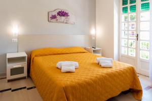 a bedroom with a bed with two towels on it at Hotel sul Mare e Lido Atena in Paestum