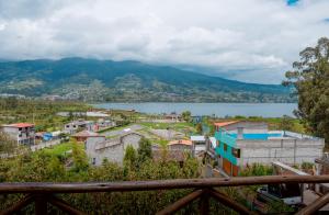 a view of a town and a body of water at Hospedaje Vertientes del Imbabura in Otavalo