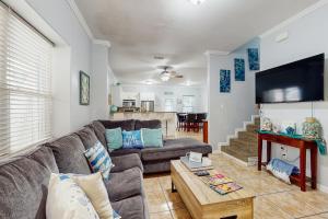 a living room with a couch and a table at Pura Vida Unit A in South Padre Island