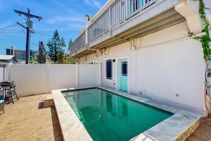 a swimming pool in the backyard of a house at Pura Vida Unit A in South Padre Island