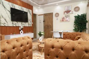 un salon avec un canapé et une télévision dans l'établissement Elegant F3, 2 chambres climatisées lits king size, Yoff plage bceao, à Dakar