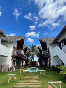 a resort with a swimming pool in the yard at Reserva BG - Apto Brisa da Barra - Frente mar in Barra Grande