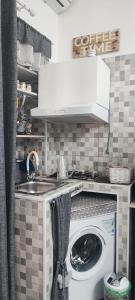 a kitchen with a washing machine and a sink at grandfather's house in Francavilla Fontana