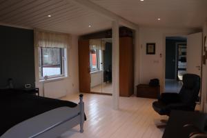 a bedroom with a bed and a living room at Bäckens Guesthouse in Älgarås