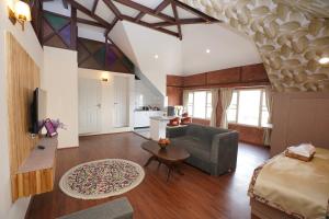a living room with a couch and a table at Maskan by Rafiqi Estates - Deluxe 2BHK & Studio Apartments in Srinagar
