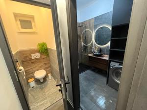a bathroom with a toilet and a washing machine at Brothers House in Balatonszárszó +65 photos
