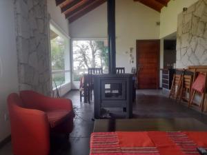 a living room with a wood stove and a table at La Juanita in Sierra de los Padres