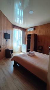a bedroom with a large bed and a television at Villa Ureki in Ureki +37 photos