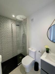 a bathroom with a toilet and a shower and a sink at Casa da Vila in Machico +13 photos