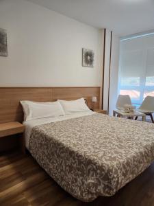 A bed or beds in a room at Hospedaje Norte
