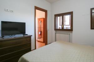 a bedroom with a bed and a flat screen tv at Central Beachfront - Sea & Food near Airport in Fiumicino +10 photos