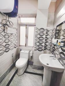 a bathroom with a toilet and a sink at Jo'stel ThinOng's HomeStay - Near MG Marg in Gangtok
