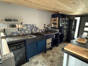 a kitchen with a sink and a refrigerator at New! Houseboat Nautigal in Wootton Bridge