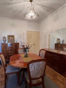 a dining room with a table and a chandelier at casa da vila in Mora +17 photos