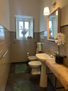 a bathroom with a sink and a toilet and a mirror at casa da vila in Mora